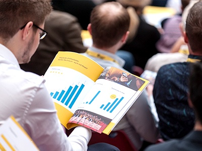 Man looking at charts during a conference