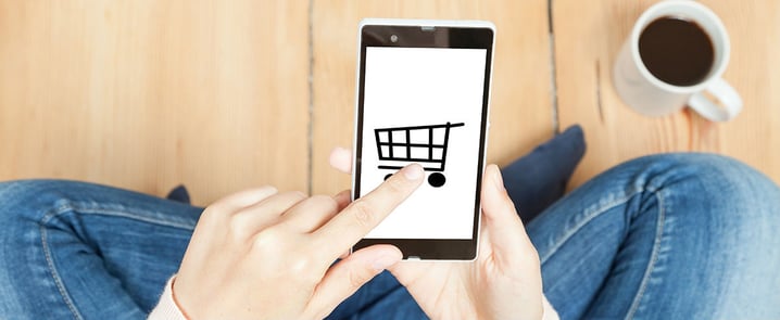 Someone is opening an App with a shopping cart logo on a smartphone.