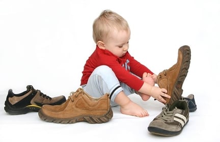 baby trying on adult shoes