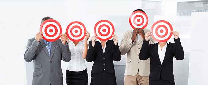 5 people holding bulls-eyes in front of their face