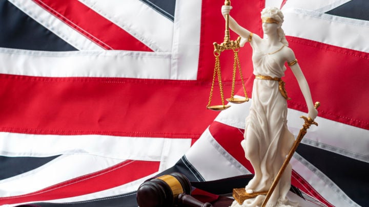 uk flag with gavel and statue of justice
