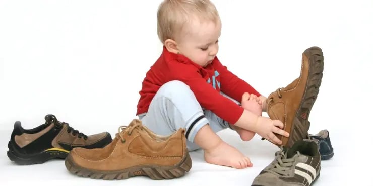 baby trying on adult shoes