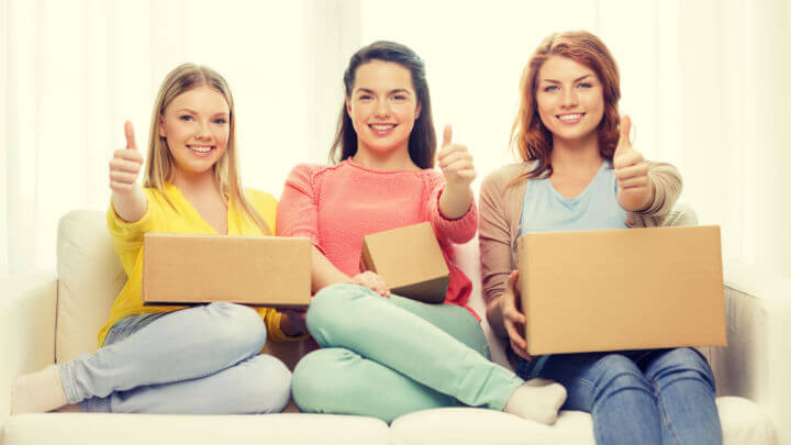 3 women happily holding open packages