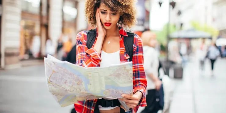 woman holding a map looking lost