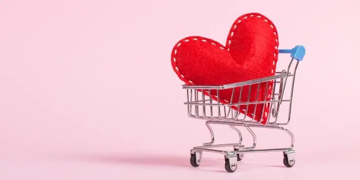 a stitched heart in a mini shopping cart