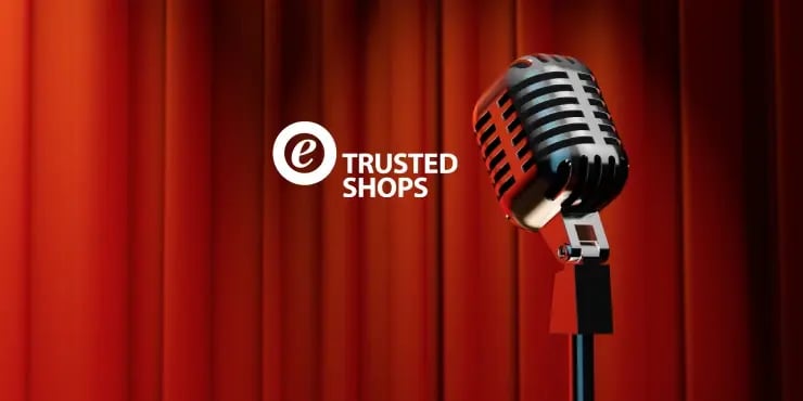 old fashioned microphone with a red curtain and the Trusted Shops logo