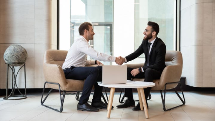 2 men in an office shaking hands