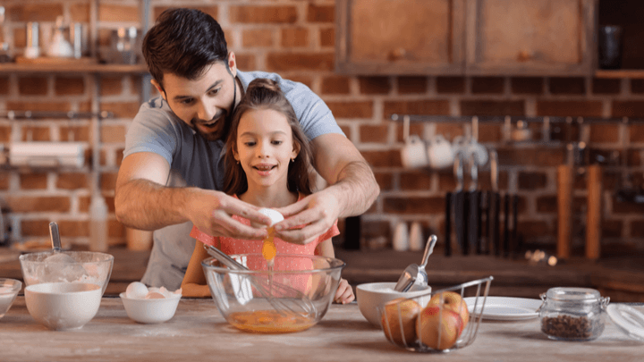 father and daughter baking together