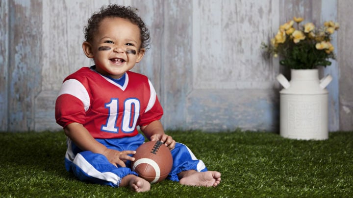 toddler playing football