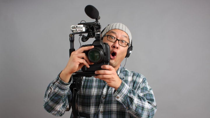 man excitedly holding camera