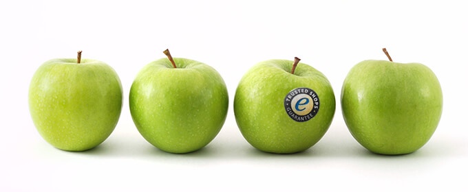 an apple with the trustmark on it among other apples that don't