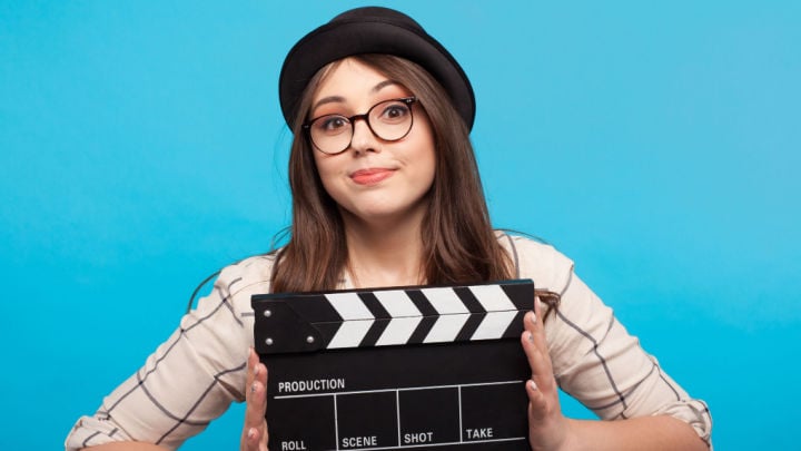 woman holding a clapperboard