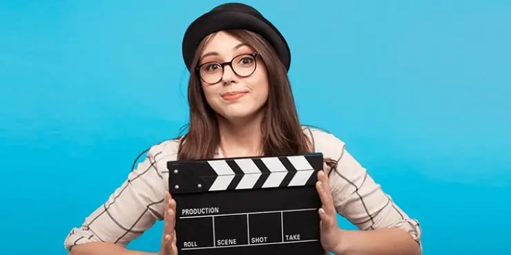 woman holding clapperboard