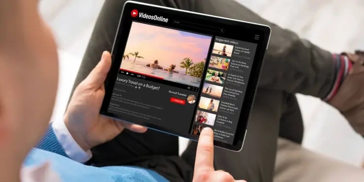 person watching YouTube videos on their tablet