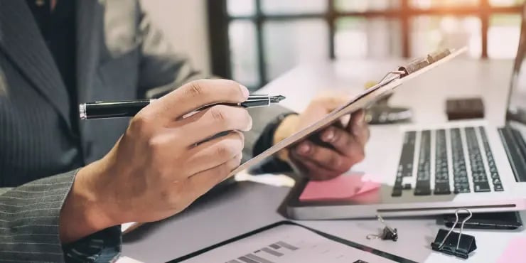 a person using a notepad to make a plan