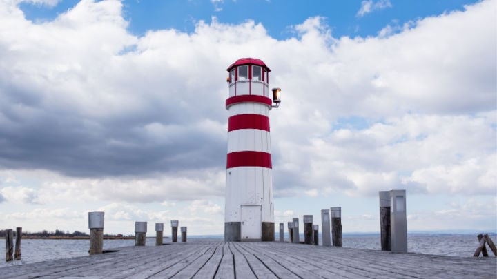 lighthouse located at the end of wooden pier