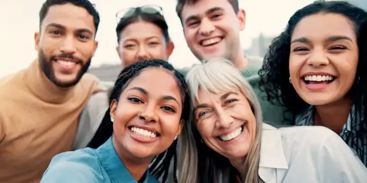 a diverse group of employees taking a selfie