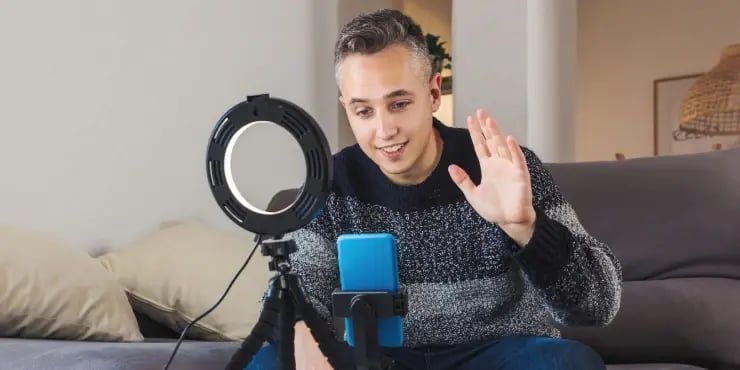 man shooting video with a ring light