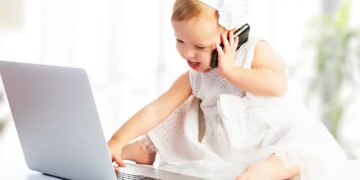 baby on the phone and using a laptop