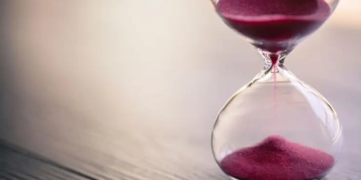an hourglass with red sand