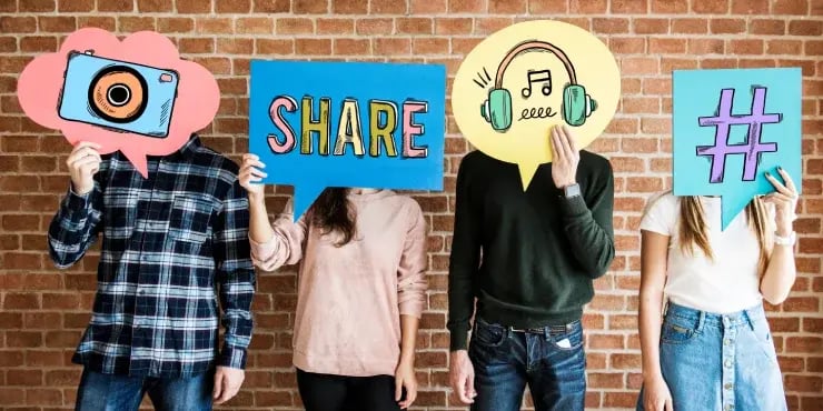 social media team holding signs with images