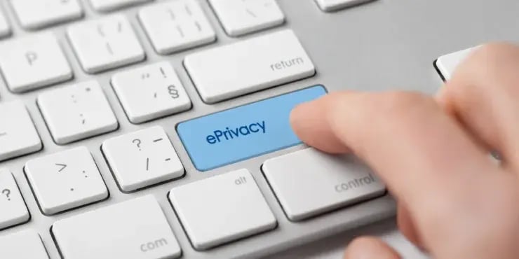 finger pressing blue button button on keyboard that says ePrivacy