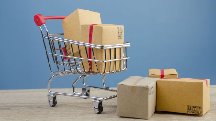 Paper boxes in a shopping cart on wood table