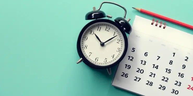 a clock, a calendar, and a red pencil