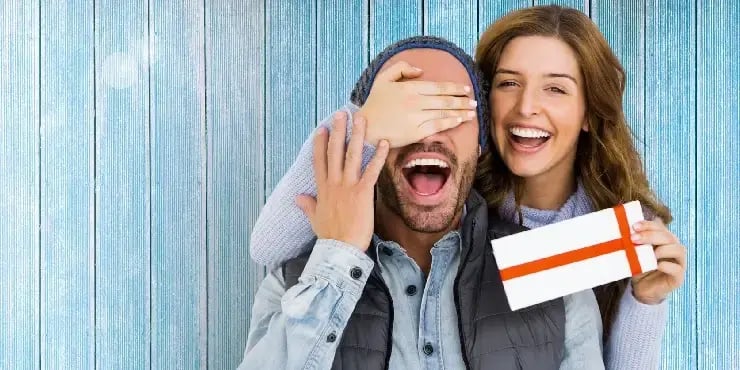 woman giving gift to boyfriend
