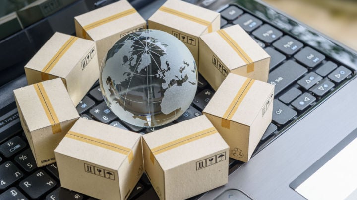 small globe surrounding by shipping boxes