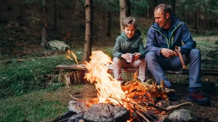 father and son telling campfire stories