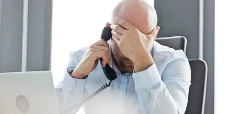 man on the phone is frustrated