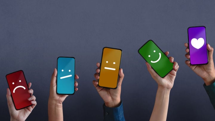 line of phones with faces ranging from frowning to smiling