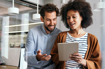 Man and woman looking at tablet