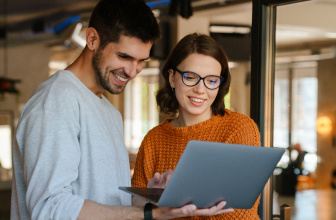 2 people looking at a laptop together
