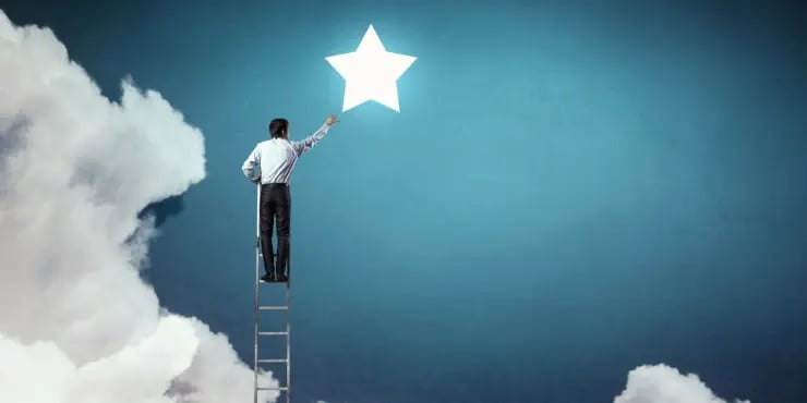 man on ladder reaching for stars