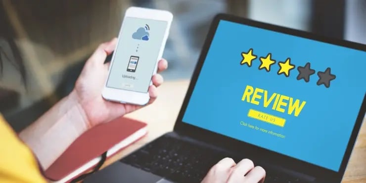 person importing reviews to laptop