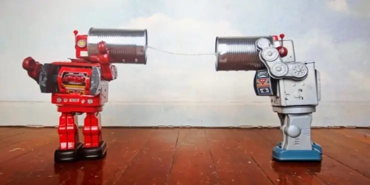 Two robots speaking to each other via tin cans.
