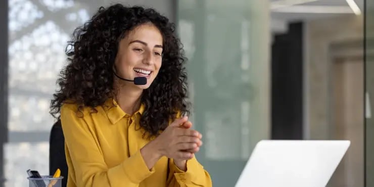 a happy customer service agent speaking on her headset